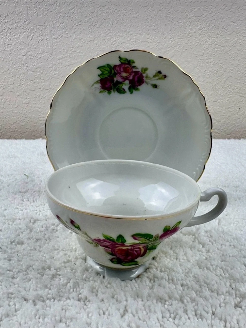Vintage Porcelain Teacup & Saucer Set Featuring Pink Roses on a White Background